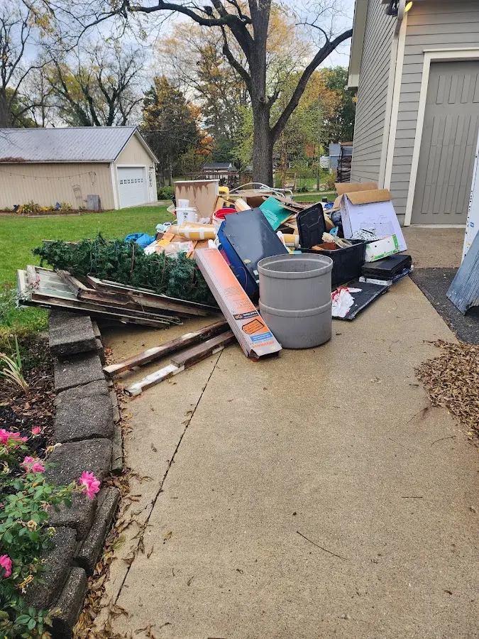 Dumpster being loaded with debris for Estate Cleanout Dumpster Rental in Northdale